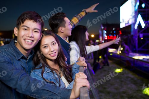 Preview: Friends Enjoying an Outdoor Concert at Night