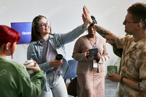 Preview: Celebrating Team Success with High-Five Gesture Enthusiastically
