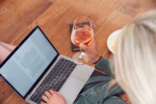 Preview: Close Up Of Businesswoman At End Of Day With Wine In Loungewear And Suit On Laptop Working At Home
