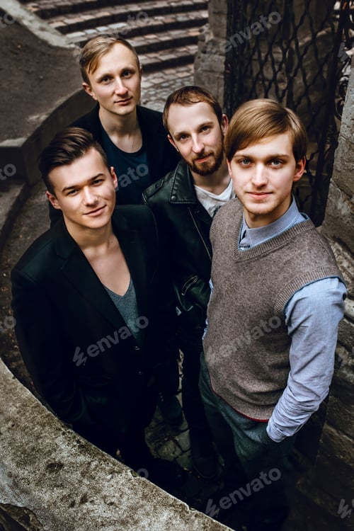 Preview: stylish handsome group of confident and successful men standing on the background of city street