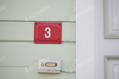 Preview: house number three. Decorative lettering on a brick wall.