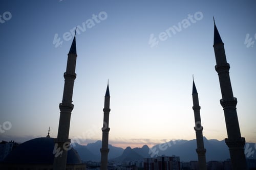 Preview: Four minarets against a sunset sky.