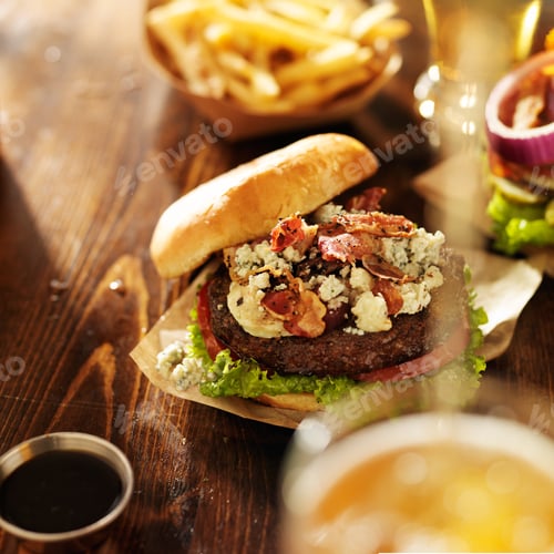 Preview: gourmet bleu cheese burgers with beer being poured
