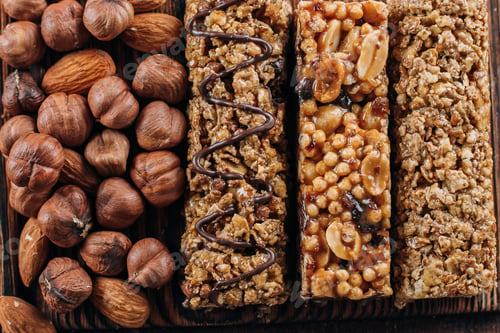 Preview: Health Bars and Mixed Nuts Background Energy bars with almond and hazelnuts. Snack for healthy