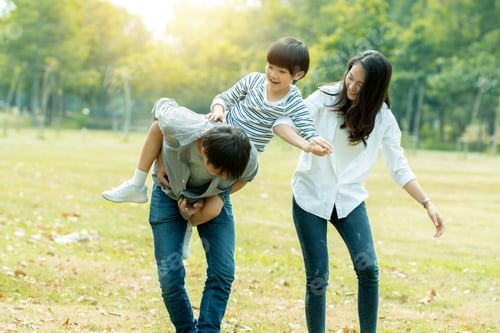 Preview: happy family, mom, dad and son walking in park