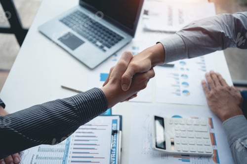 Preview: Business success. Businesspeople shake hands to confirm agreements to do business together and inves