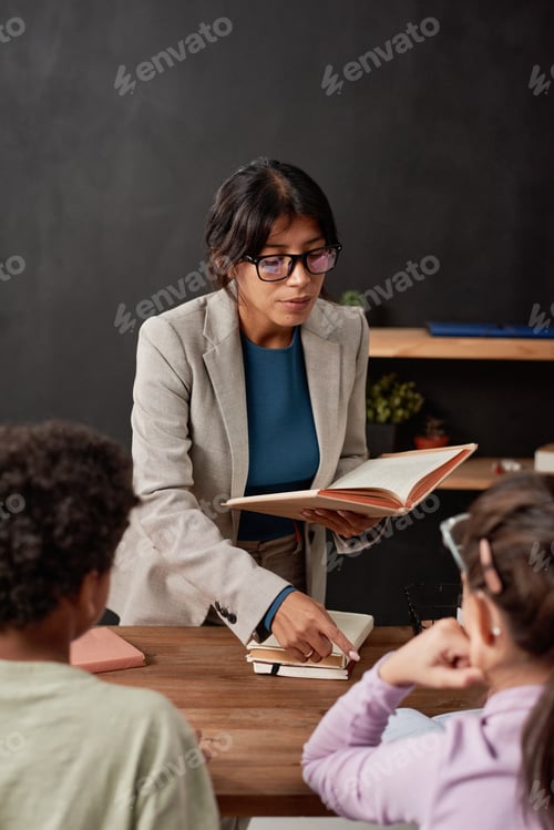 Preview: Mixed race teacher explaining new topic to kids