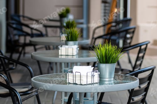 Preview: row of tables with chairs pass into blurred street