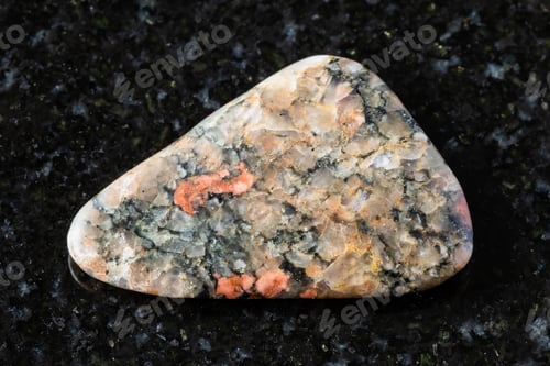 Preview: tumbled gneissoid granite mineral on black