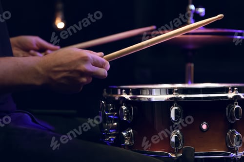 Preview: Drummer playing snare drum with sticks close up.