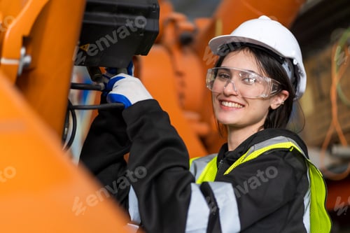 Preview: A team of female engineers meeting to inspect computer-controlled steel welding robots.