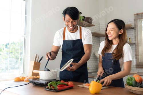 Preview: Romantic couple is cooking on kitchen. Handsome man and attractive young woman are having fun