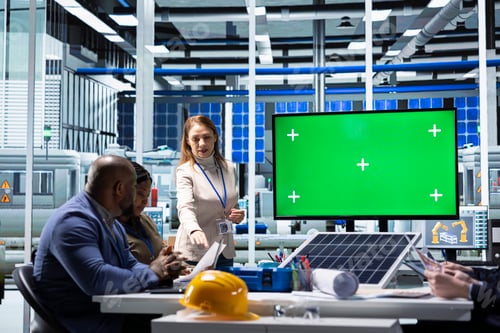 Preview: Photovoltaics factory team looking at green screen display