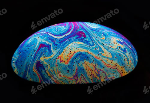 Preview: Close-up shot of a rainbow soap bubble in a dark background.