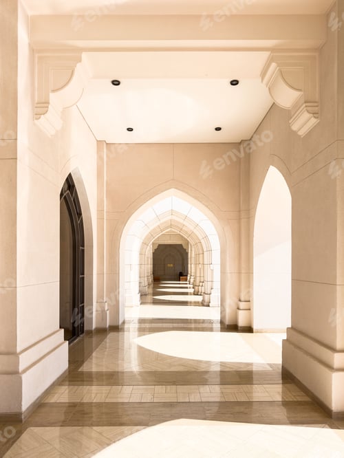 Preview: A sunlit corridor with arched doorways and intricate architectural details