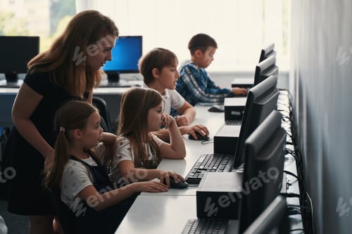 Preview: Helpful teacher working in the ICT class