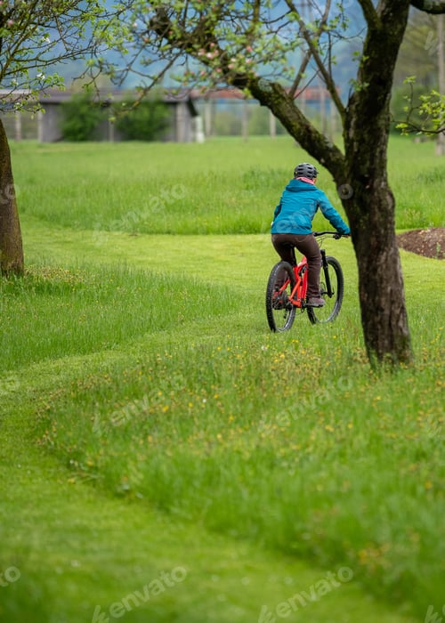 Preview: A young female is cycling through the countryside