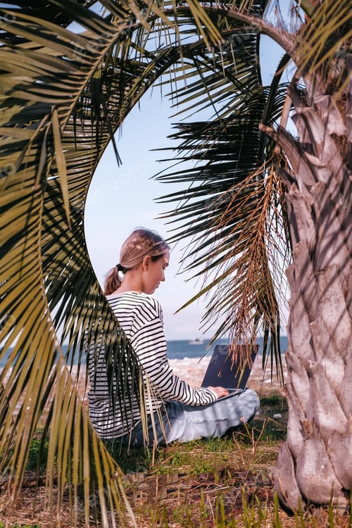 Preview: Remote work.Girl freelancer works remotely sea shore. workation, remote work,leisure, work life bala