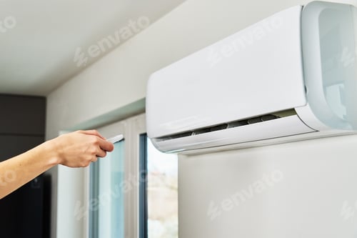 Preview: Hand adjusting temperature on air conditioner