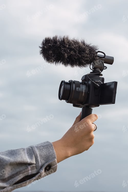 Preview: Anonymous female blogger shooting video on camera