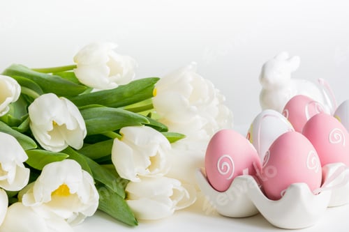 Preview: Easter concept. White tulips, colorful eggs on white.
