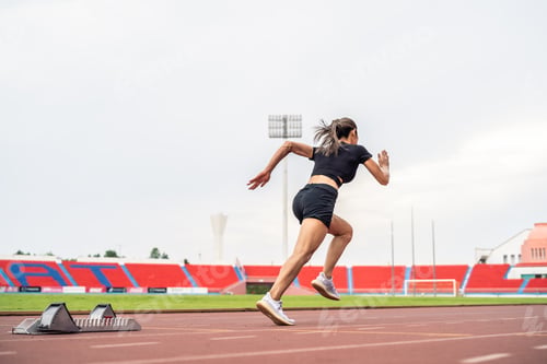 Preview: Asian young sportswoman sprint on a running track outdoors on stadium.