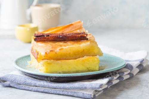 Preview: Custard of "Galaktoboureko" or bougatsa Greek traditional dessert baked in a pan with syrup. closeup