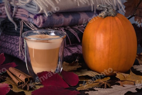 Preview: Glass cup with pumpkin latte and ripe pumpkin stand on table