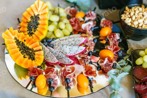 Preview: Colorful Fruit and Prosciutto Skewers on Reflective Tray