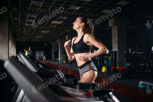 Female athlete on a treadmill in sport gym