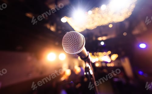 Preview: Microphone on stage against a background of auditorium.
