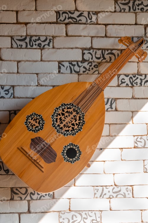 Preview: Traditional arabic musical instrument on brick wall.