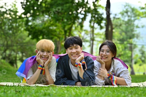 Preview: Group of young activist with pride rainbow flag in their backs supporting LGBTQ community.