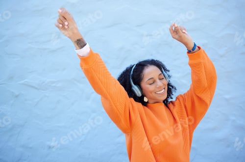 Preview: Black woman, hands up or dancing to headphones music on isolated blue background, fashion mockup or