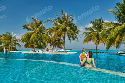Preview: Toddler boy in resort swimming pool with mother