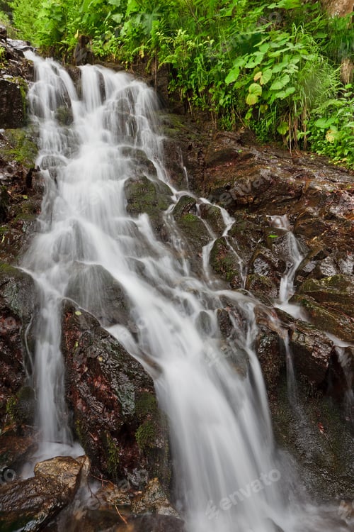 Preview: Waterfall Flowing Over Rocks in Nature Setting