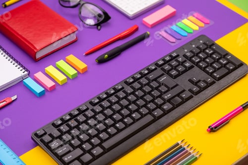 Preview: Modern working place with keyboard, diary, pencils, pens and glasses on orange-purple background