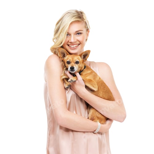 Smiling Woman Holding Cute Dog in Studio Light