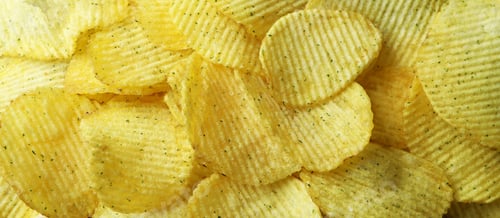 Preview: Tasty potato chips on whole background, close up