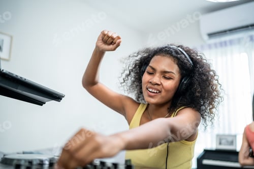 Preview: African American woman DJ mixing and scratching music mixer controller.