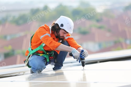 Preview: Workers Installing Solar Panels on warehouse Roof.