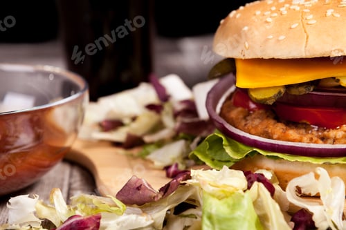 Preview: Close up of Delicious home made burger on wooden plate