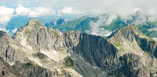 Preview: Panoramic view of Tatra mountain peaks and rocks covered with clouds