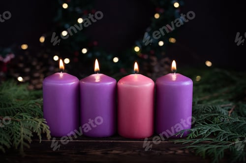Preview: A row of four burning purple advent candles Christmas concept.