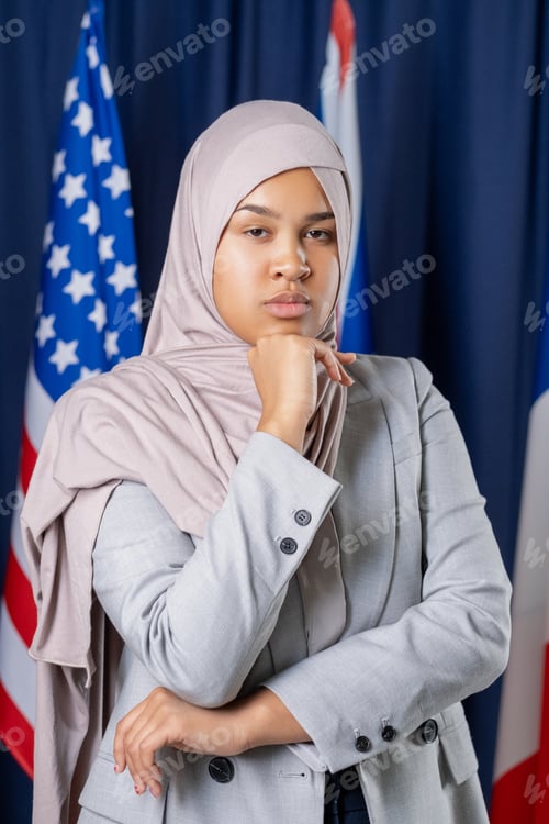 Preview: Young serious woman in hijab and formalwear looking at you
