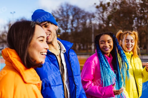 Preview: Multiracial group of young friends meeting outdoors in winter