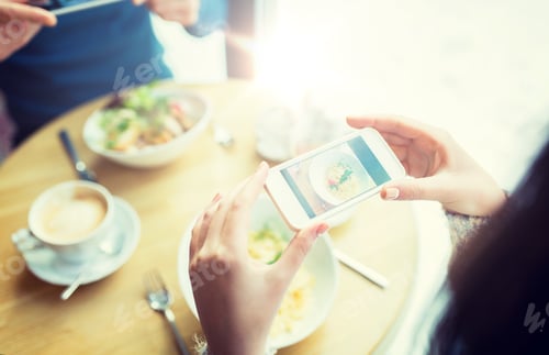 Preview: close up of couple picturing food by smartphone