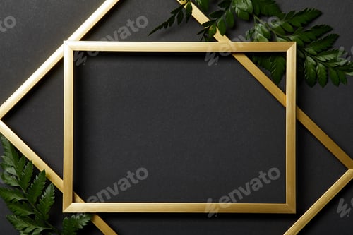 Preview: top view of empty golden frames on black background with copy space and green fern leaves