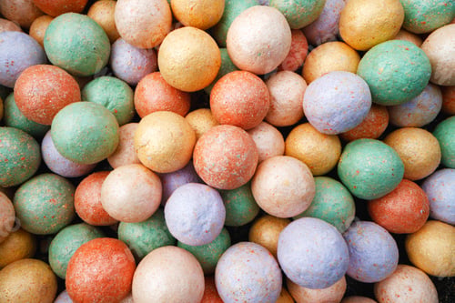 Preview: Multicolored make-up powder balls background close up