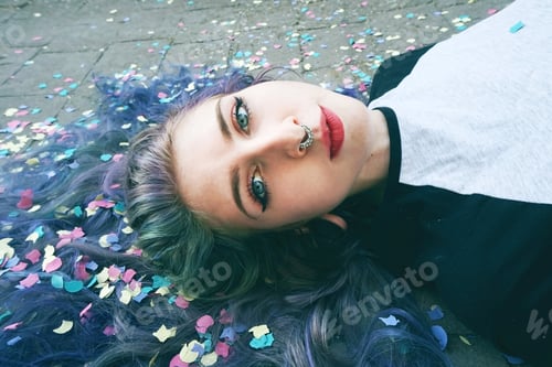 Preview: Beautiful young woman surrounded by confetti